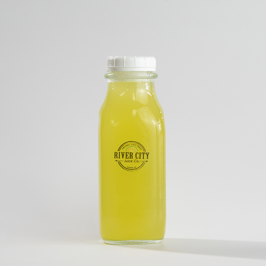 Bottle of yellow juice with 'River City Juice Co.' label on a white background