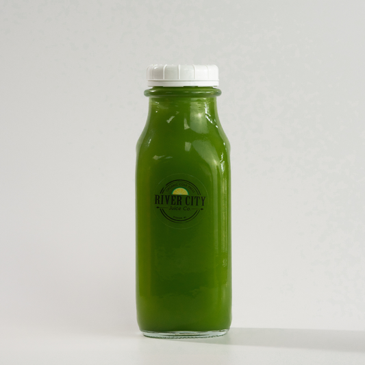 Bottle of green juice with a white cap on a white background